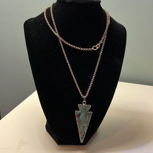 N67. Long necklace with green pendant.